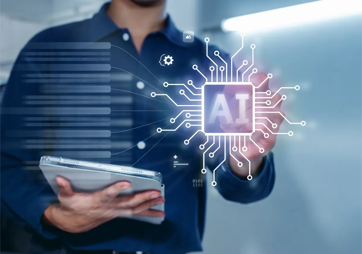 Person holding a tablet with a glowing AI chip graphic