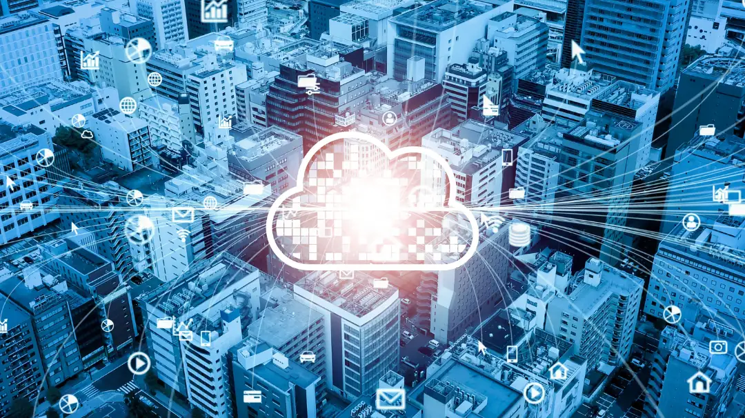 Glowing cloud icon above a city business district with connected devices