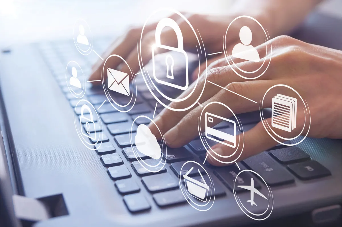 Hands typing with padlock, email and data icons overlaid